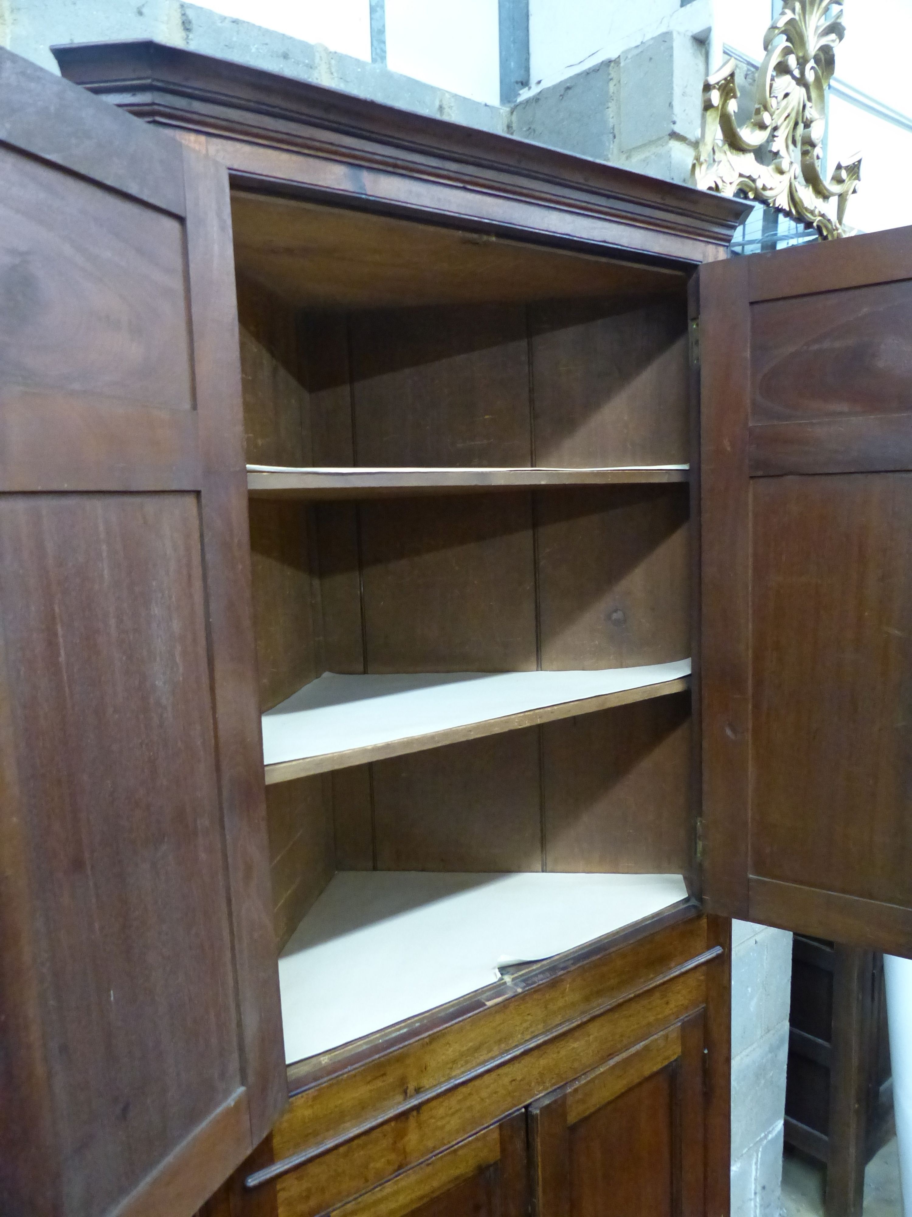 A George III mahogany four door standing corner cabinet, W.90cm D.48cm H.190cm